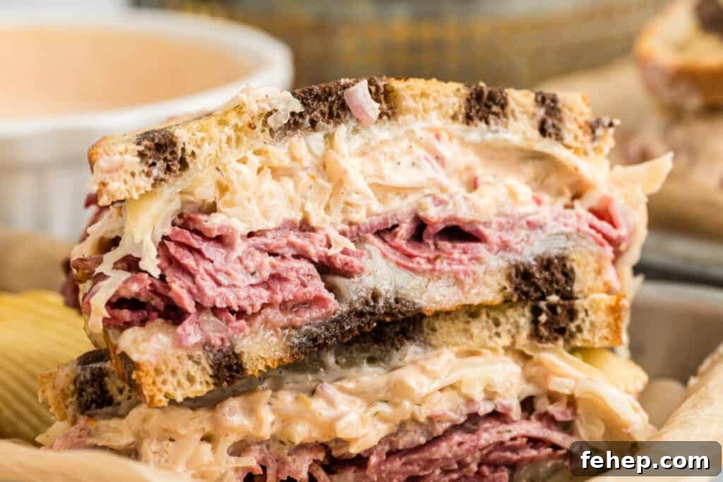 Classic Reuben Sandwich Recipe: Crispy Corned Beef & Melted Swiss 6 reuben sandwich sliced in half on plate