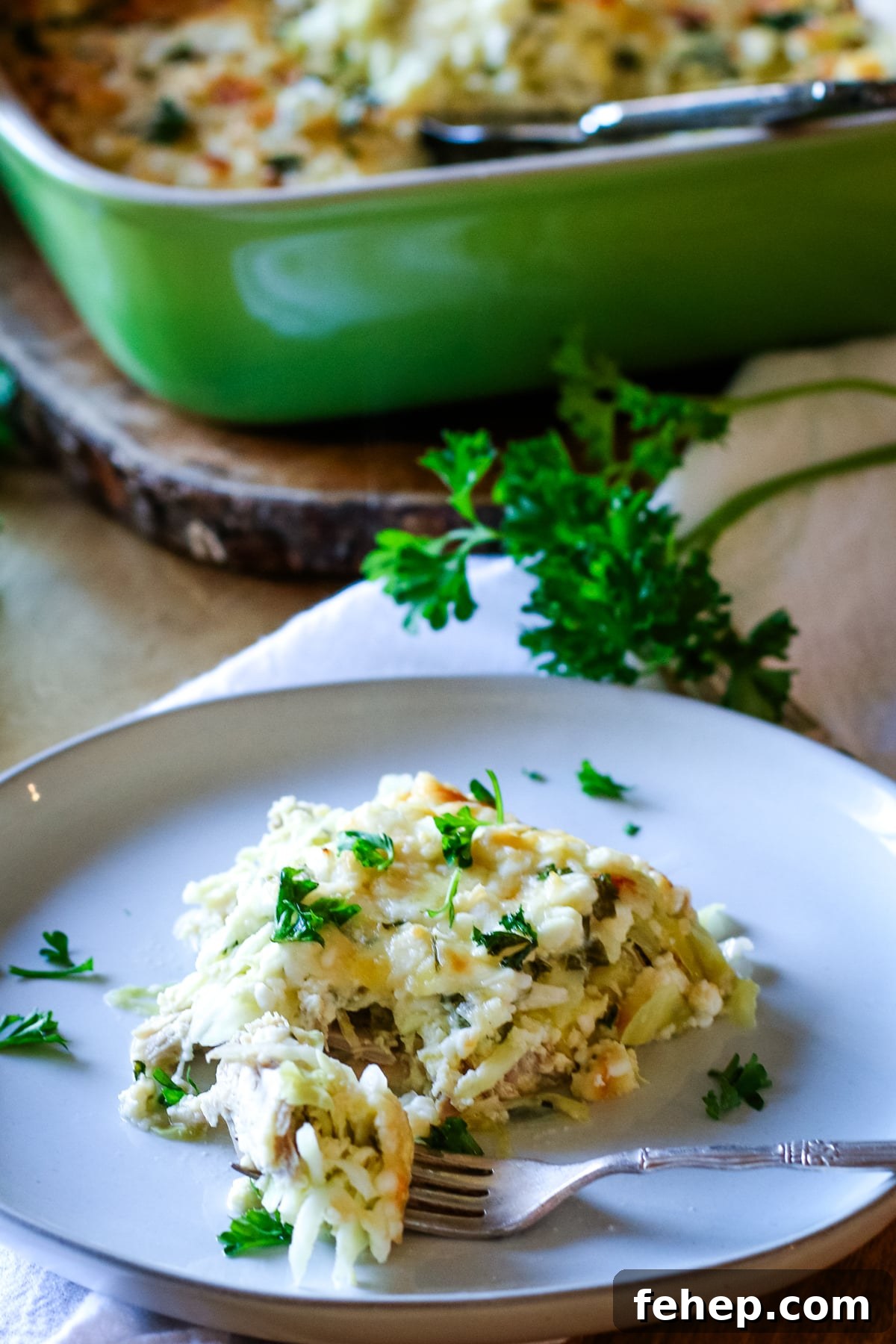 chicken casserole on a white plate with fork on the side.