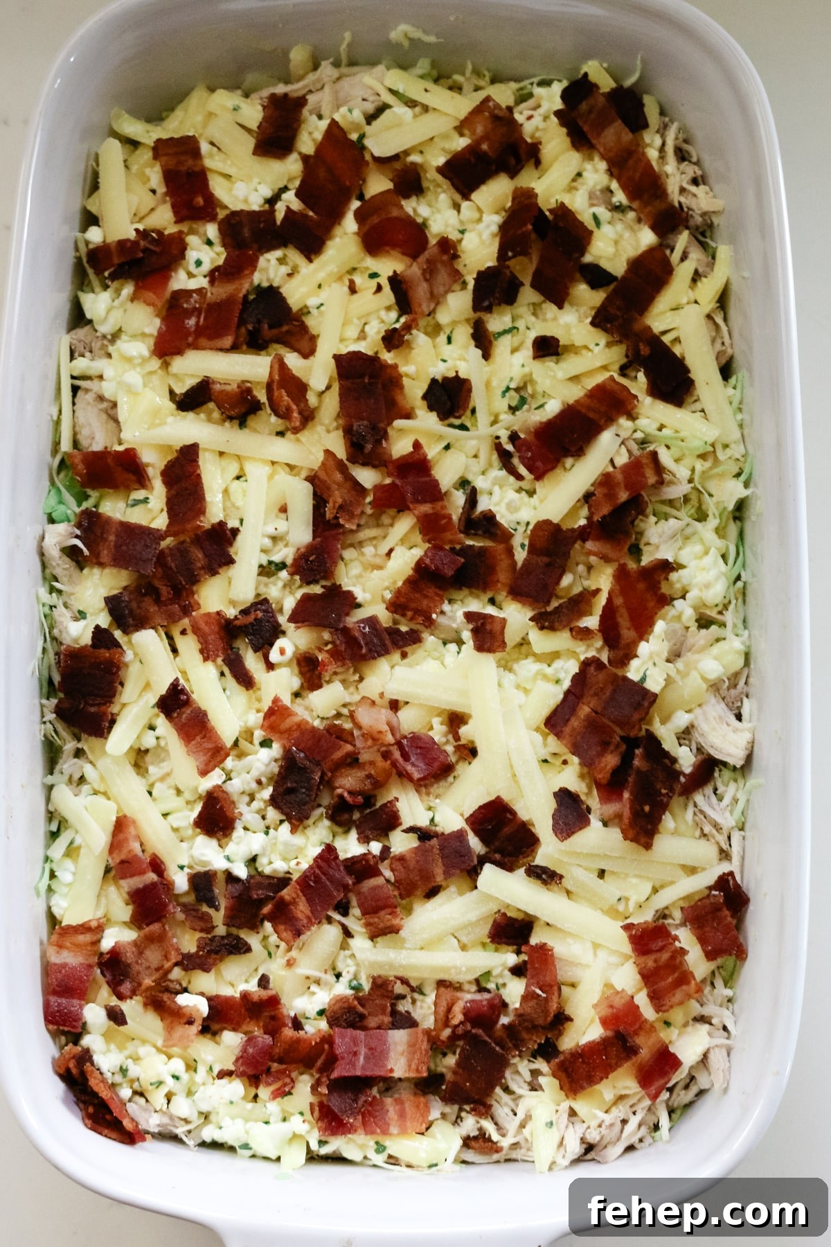 cabbage bake with bacon bits and shredded cheese on top.