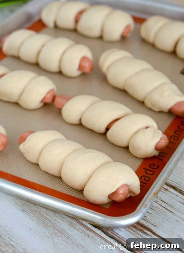 How to make the best pigs in a blanket. Made from scratch pigs in blankets. A kid favorite recipe! hot dogs wrapped in homemade dough on a cookie sheet