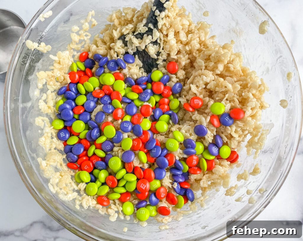 Add the M&Ms to the Rice Krispie Mixture at the last minute