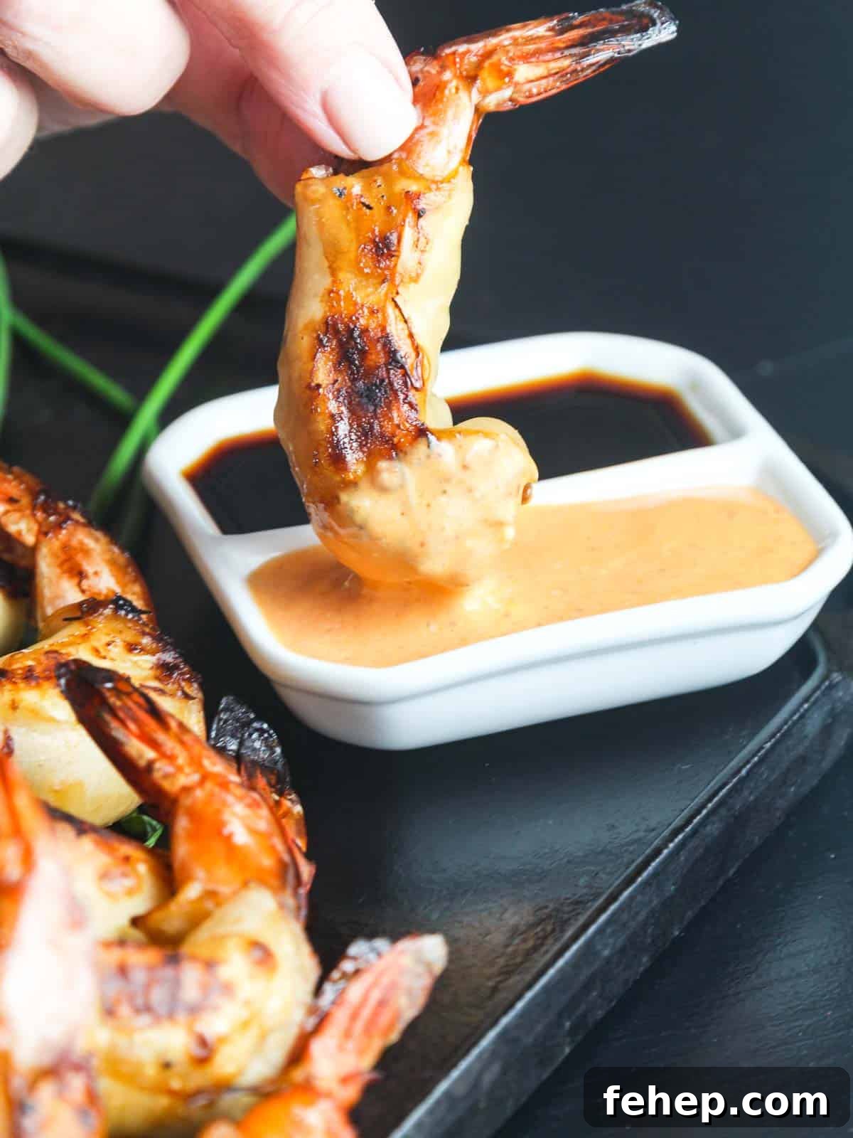 Crispy Firecracker Shrimp Recipe with Sweet-Spicy Sauce 3 Dipping a firecracker shrimp in sauce