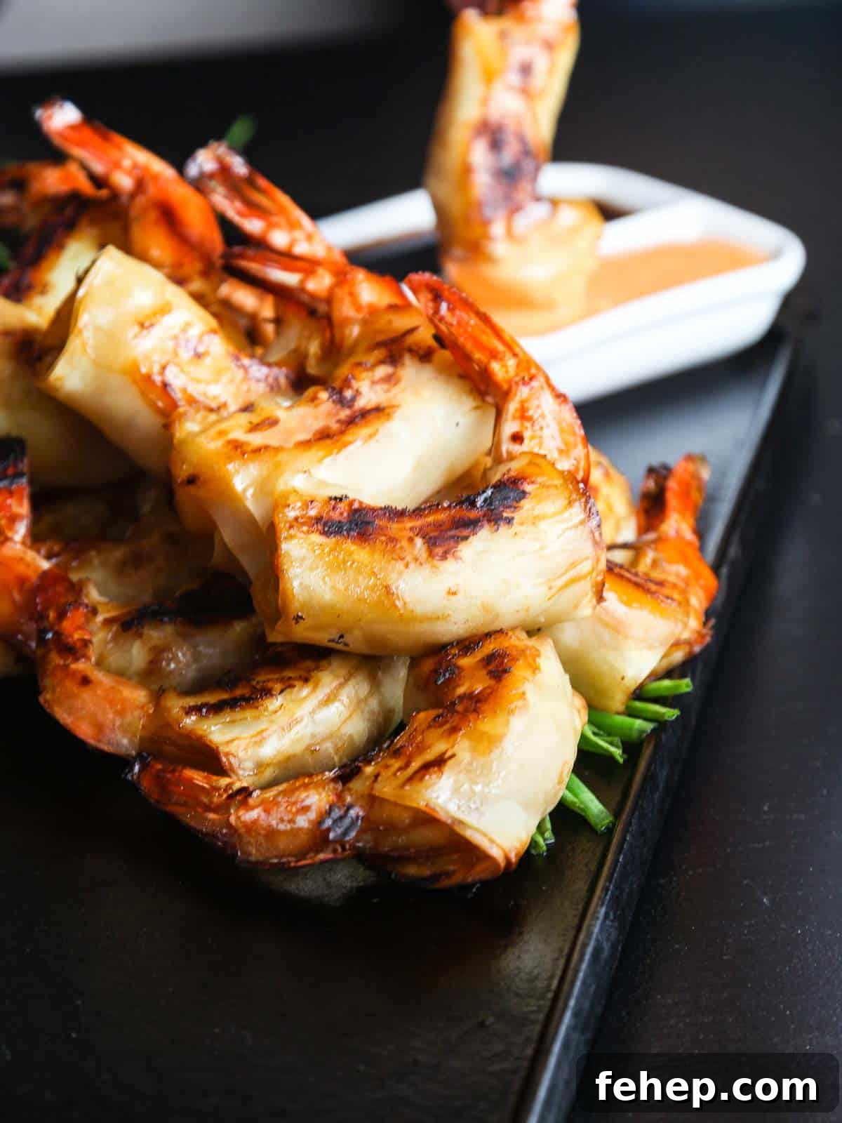 Crispy Firecracker Shrimp Recipe with Sweet-Spicy Sauce 5 Dipping firecracker shrimp into sauce