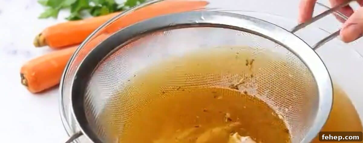 Classic Chicken and Dumplings Recipe for Comforting Weeknight Dinner 7 Straining the chicken broth through a mesh strainer.
