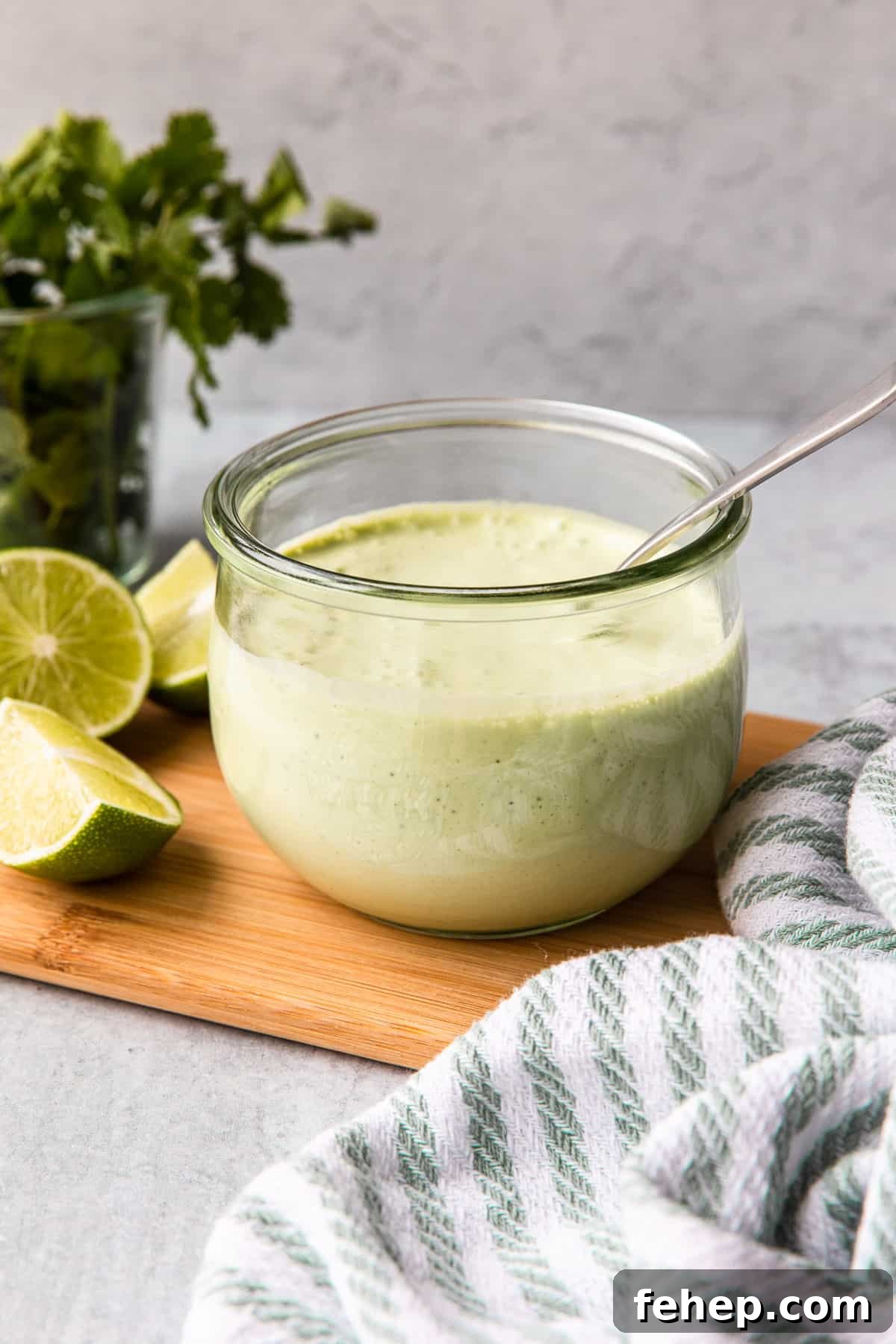 a glass container of cilantro garlic sauce
