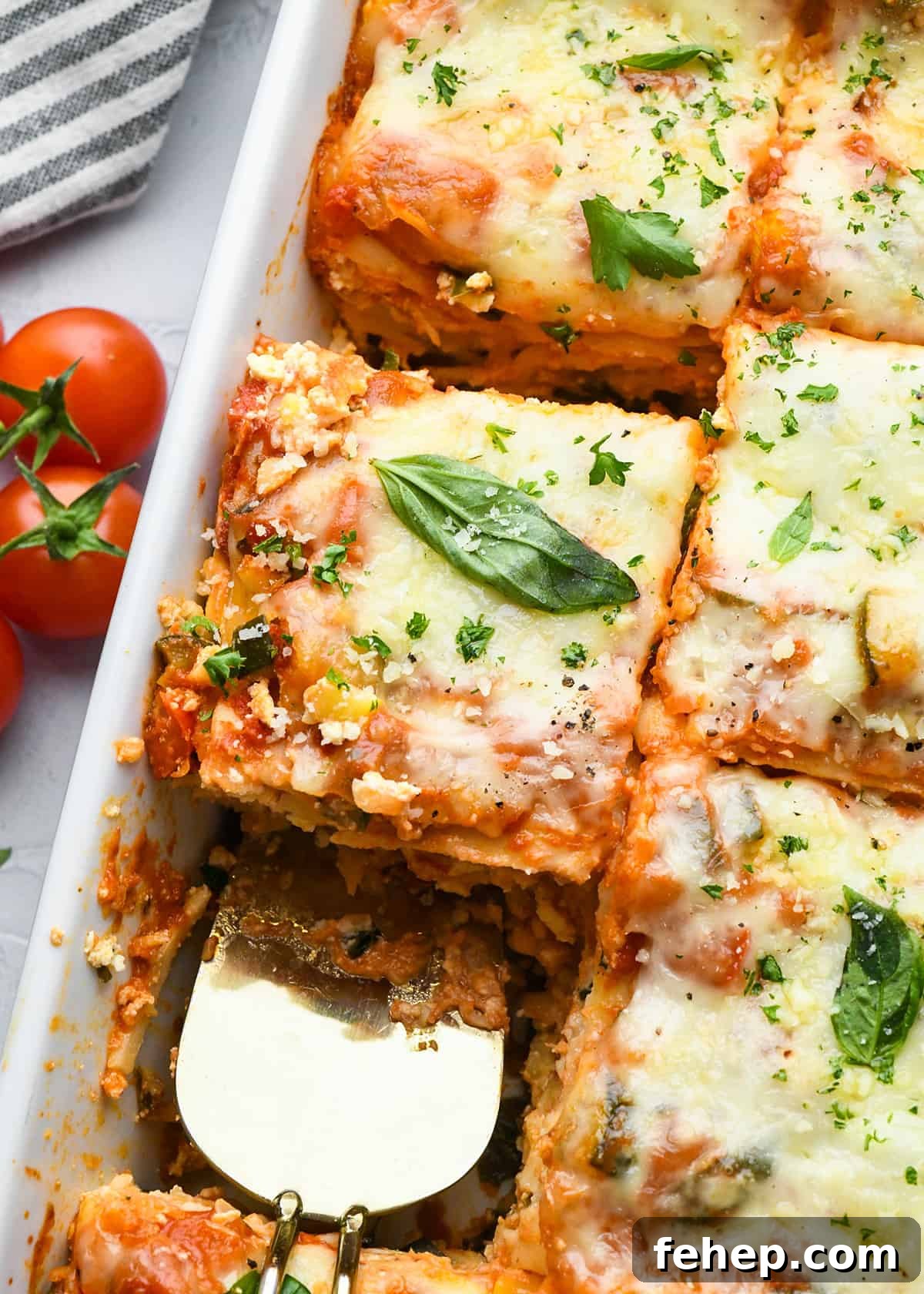 Hearty Vegetable Lasagna Recipe with Spinach & Ricotta 14 vegetarian lasagna in a baking dish cut into pieces