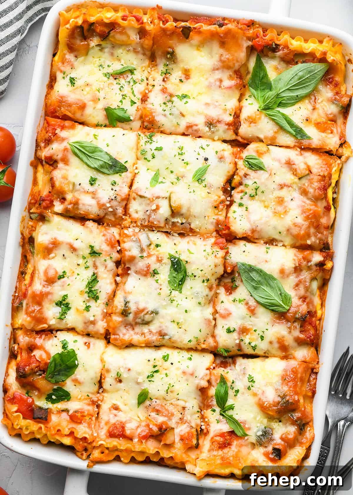 Hearty Vegetable Lasagna Recipe with Spinach & Ricotta 5 Vegetable Lasagna in a baking dish cut into 12 pieces