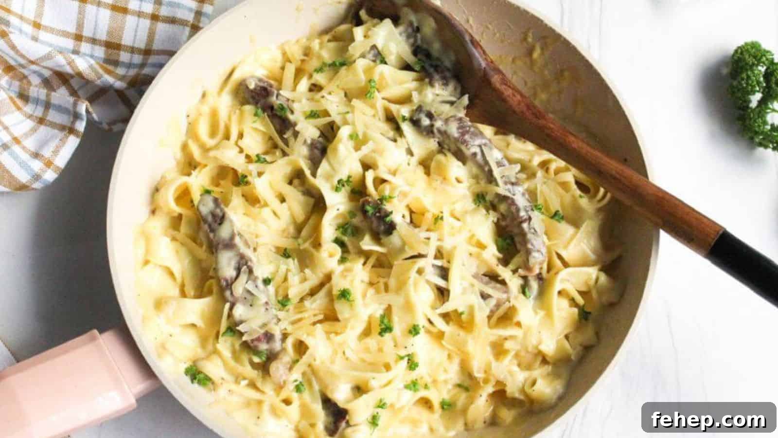 19 Authentic Italian Dinners That Feel Effortless and Homey 3 Alfredo steak pasta in skillet with wooden spoon.