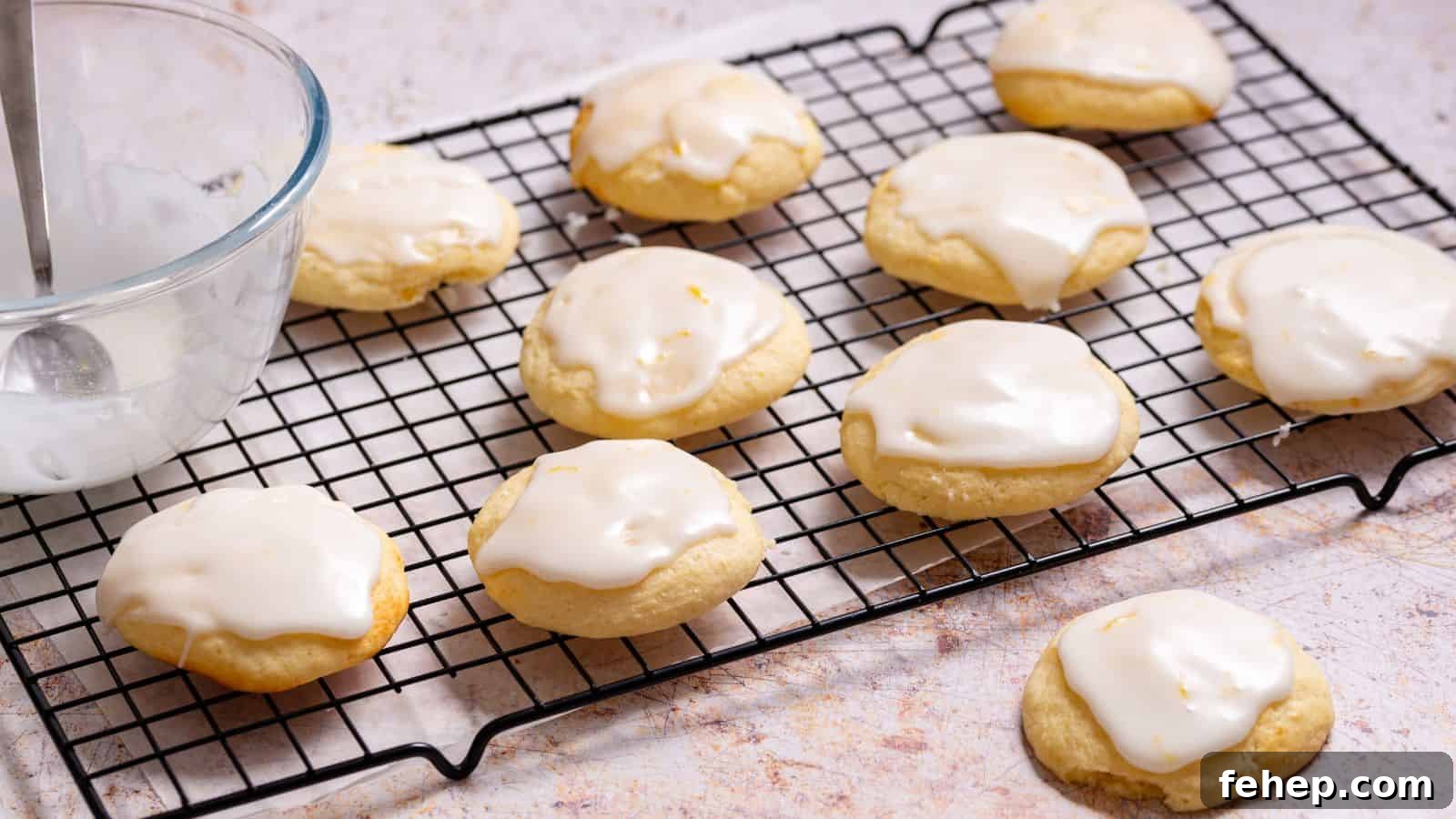 19 Authentic Italian Dinners That Feel Effortless and Homey 4 Lemon ricotta cookies on rack with icing bowl.