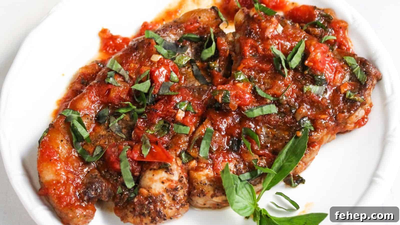 19 Authentic Italian Dinners That Feel Effortless and Homey 6 Fried steak topped with a chunky tomato and basil sauce, served on a white plate.