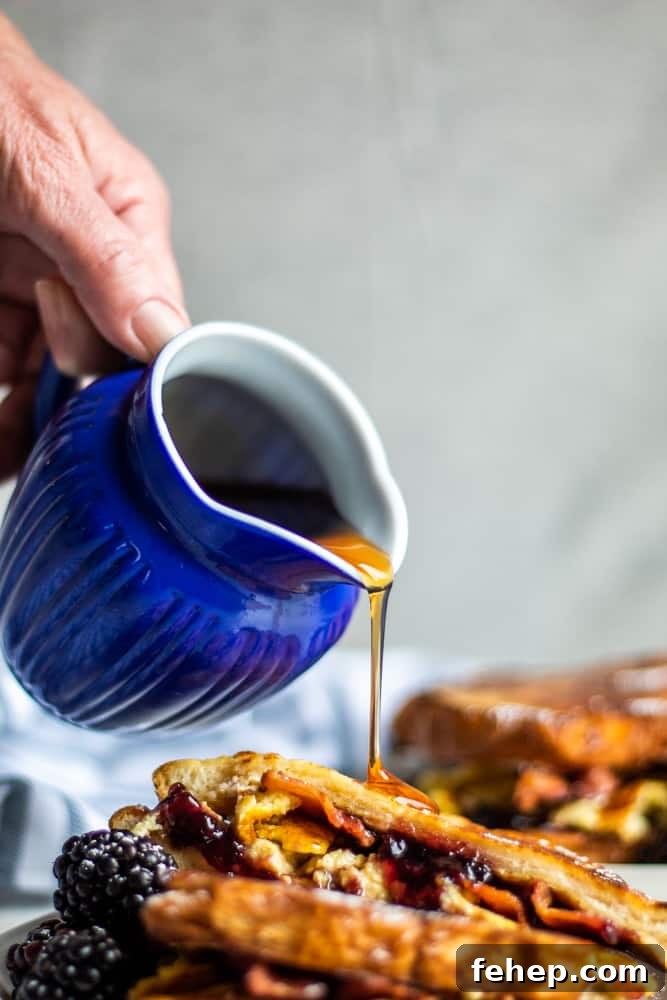 Maple syrup over french toast Hand pouring maple syrup over stuffed french toast.