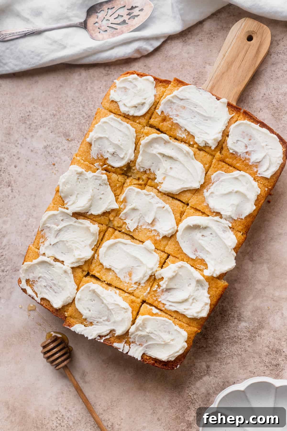 Honey Butter Cornbread Recipe — Sweet Savory Cornbread Guide 9 Cornbread with butter on top of cutting board.