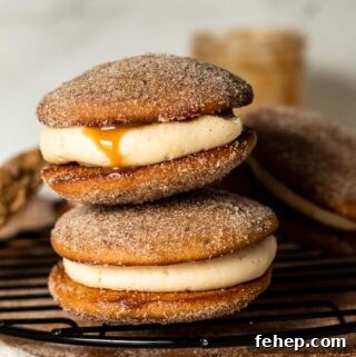 Apple Cider Whoopie Pies Recipe for Fall Baking Success 13 Two apple cider whoopie pies on a baking rack.
