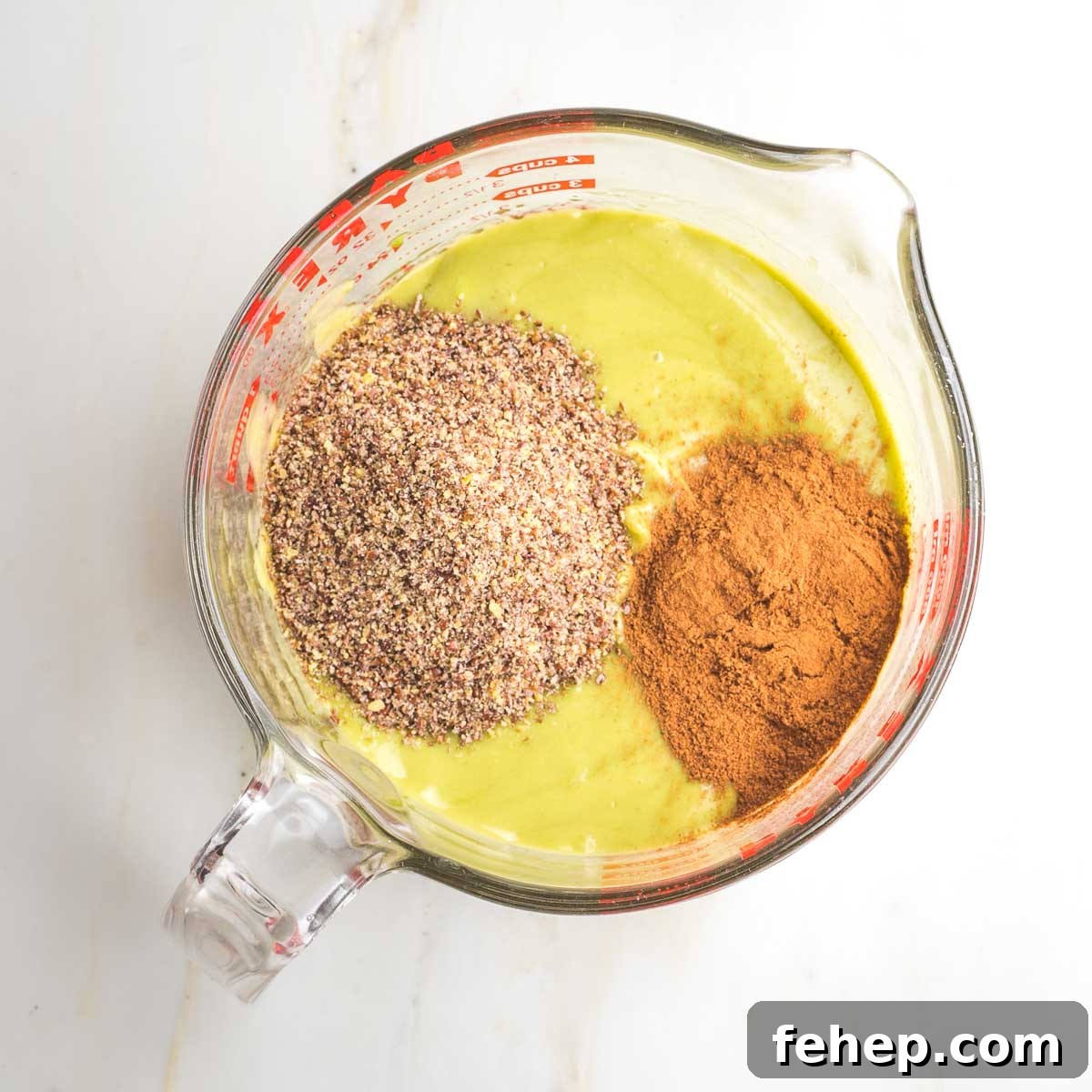 Light green creamy mixture with ground flax and cinnamon.