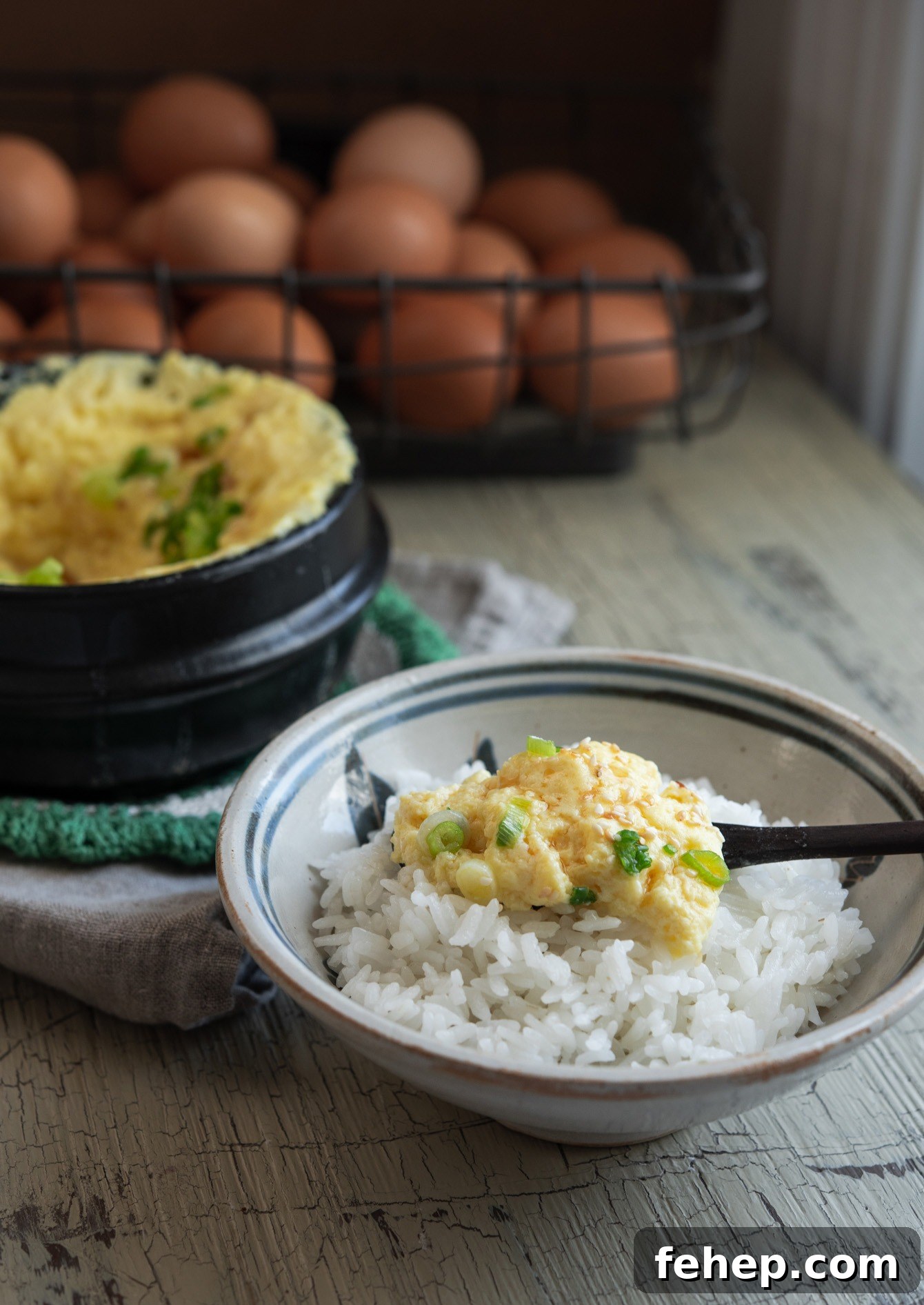 Soft and smooth Korean steamed eggs (gyeran jjim) served with a bowl of rice.
