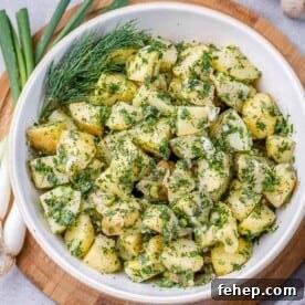 Classic Herbed Potato Salad with Fresh Dill and Chives 11 top view potato salad with green herbs in a white round bowl