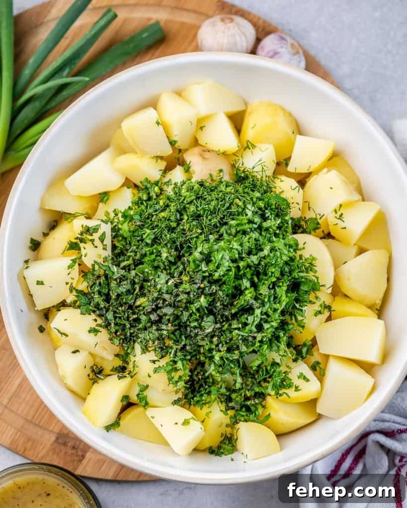 Classic Herbed Potato Salad with Fresh Dill and Chives 6 Adding herbs to boiled potatoes.