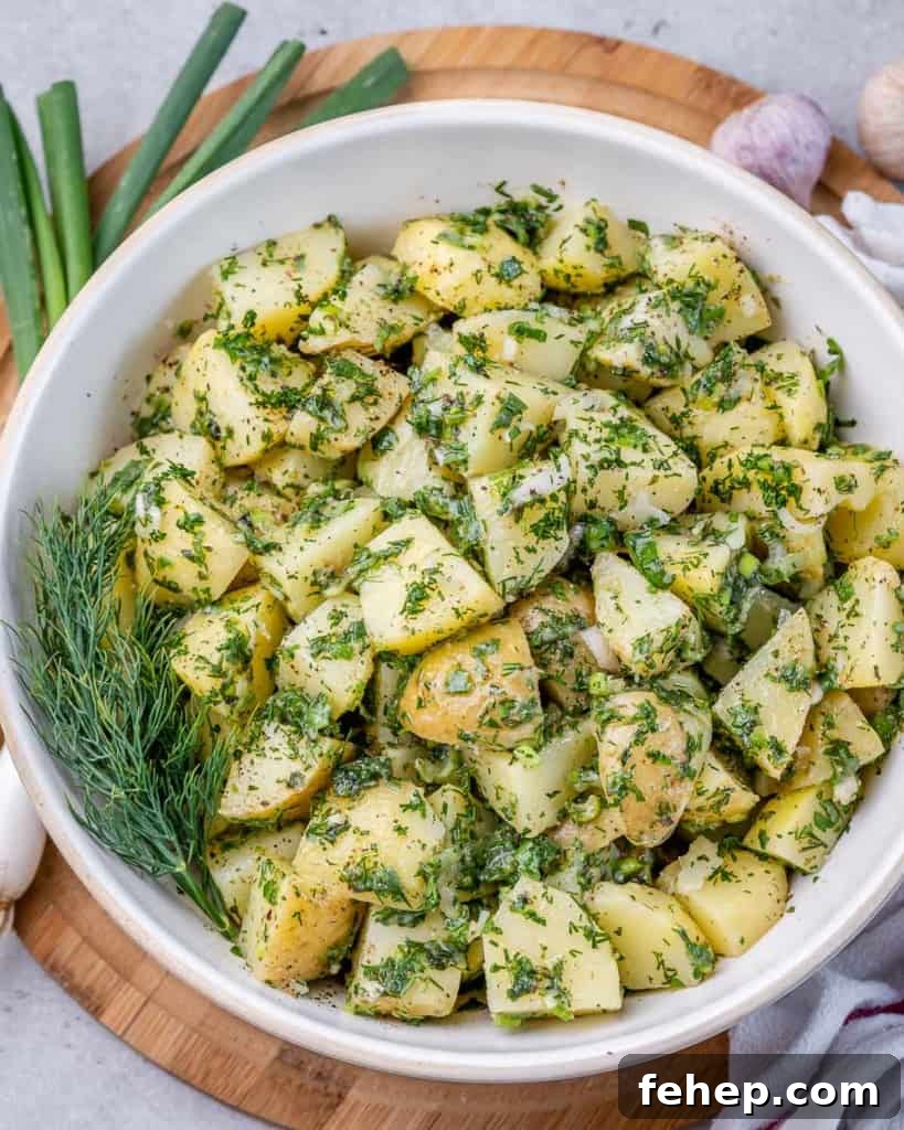 Classic Herbed Potato Salad with Fresh Dill and Chives 8 top view potato salad coated with green herbs in a round white bowl