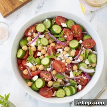 Tomato and cucumber salad, with red onion, feta, and garbanzo beans with greek dressing.