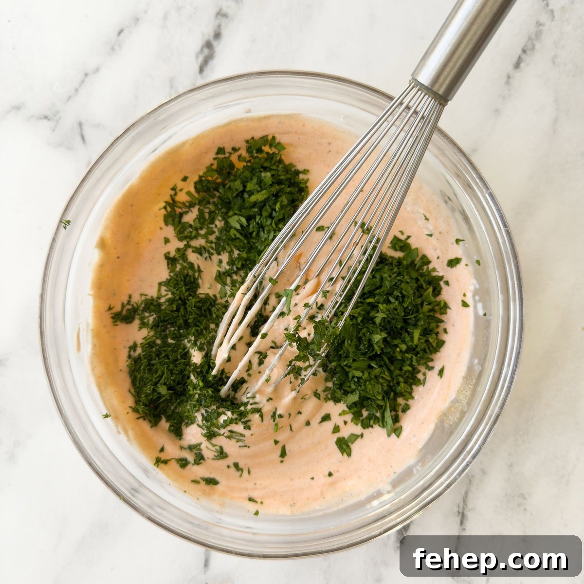 Spicy Buffalo Chicken Salad Recipe with Creamy Ranch Dressing 9 Adding fresh chopped green herbs to a bowl of buffalo ranch dip.