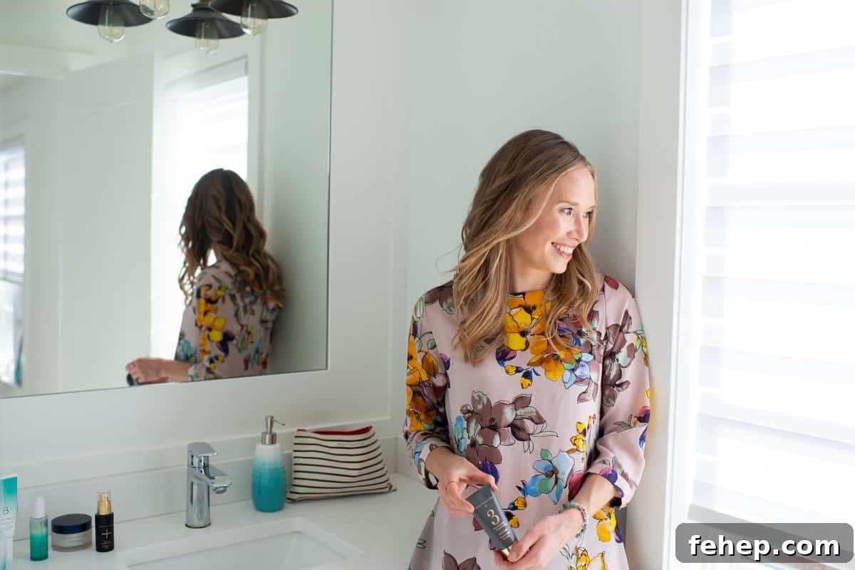 Erin Carter in her bathroom holding a charcoal mask.