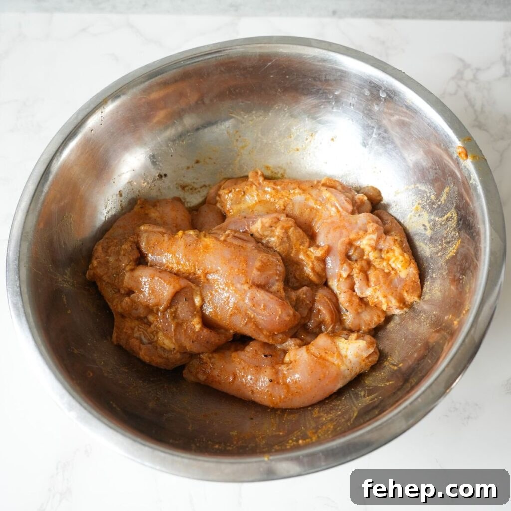 Chicken thighs marinating in a bowl. 