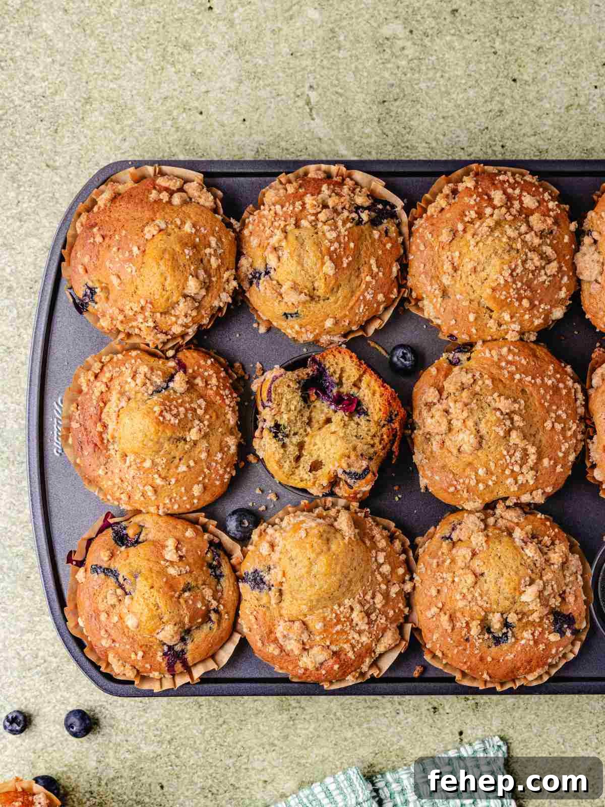 Cottage cheese muffins in  muffin tins on a flat surface.