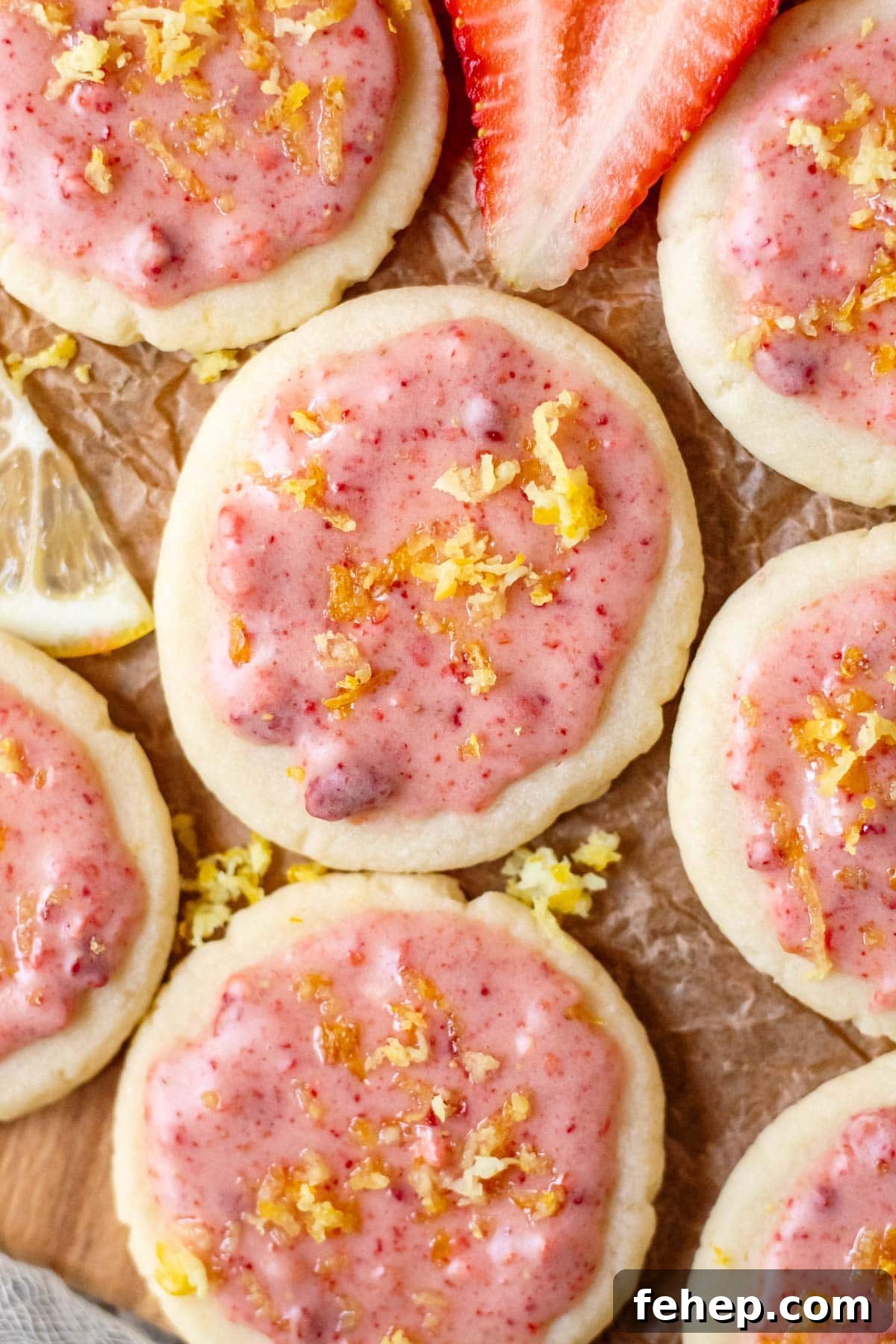 Lemon Shortbread Cookies with Strawberry Glaze Recipe 2 lemon shortbread cookies with strawberry glaze on parchment paper