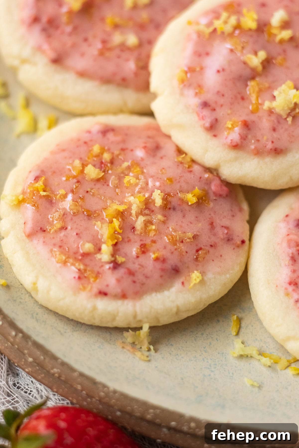 Lemon Shortbread Cookies with Strawberry Glaze Recipe 16 lemon shortbread cookies with strawberry glaze on a gray plate