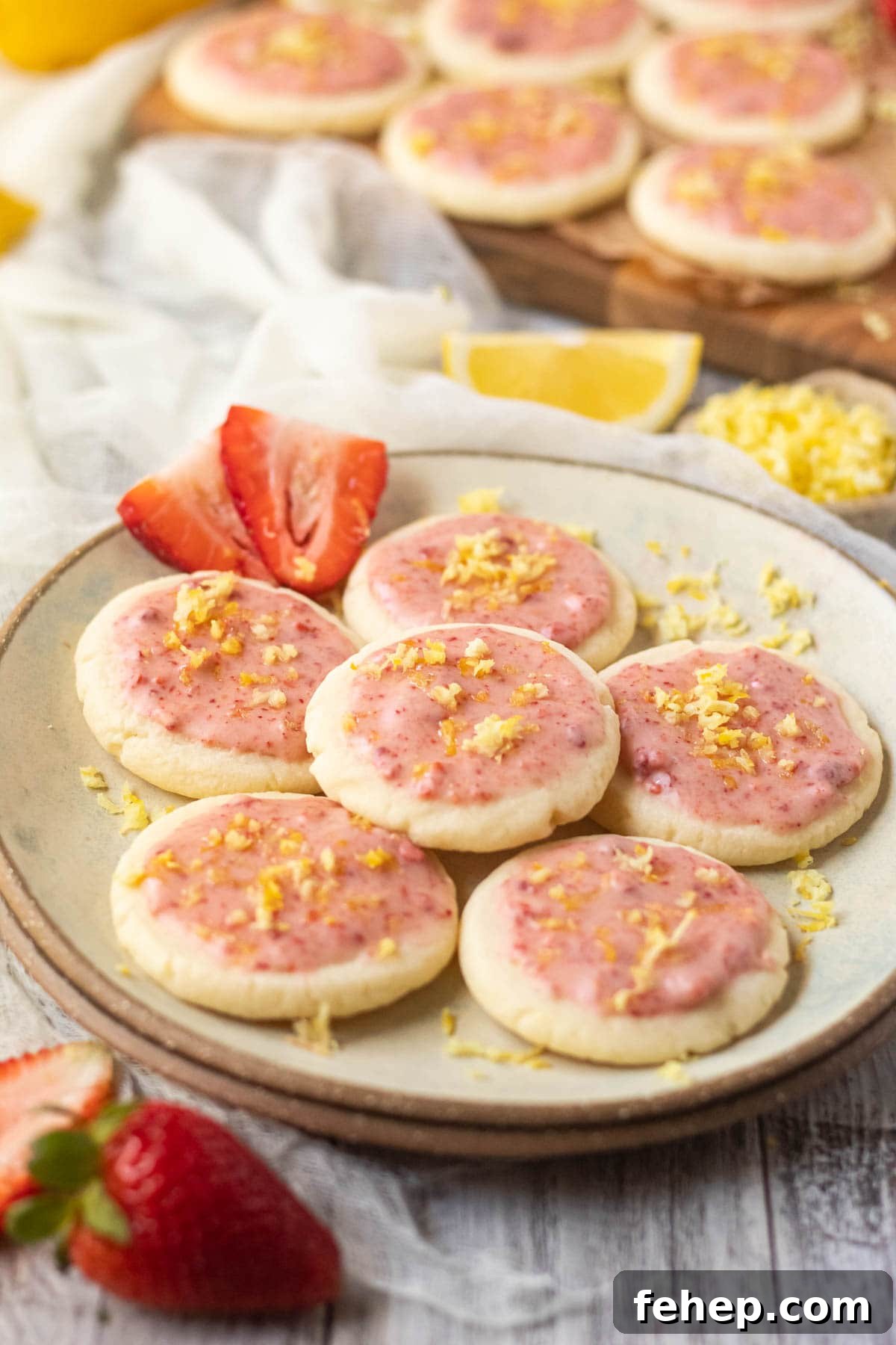 Lemon Shortbread Cookies with Strawberry Glaze Recipe 3 lemon shortbread cookies with strawberry glaze on a gray plate