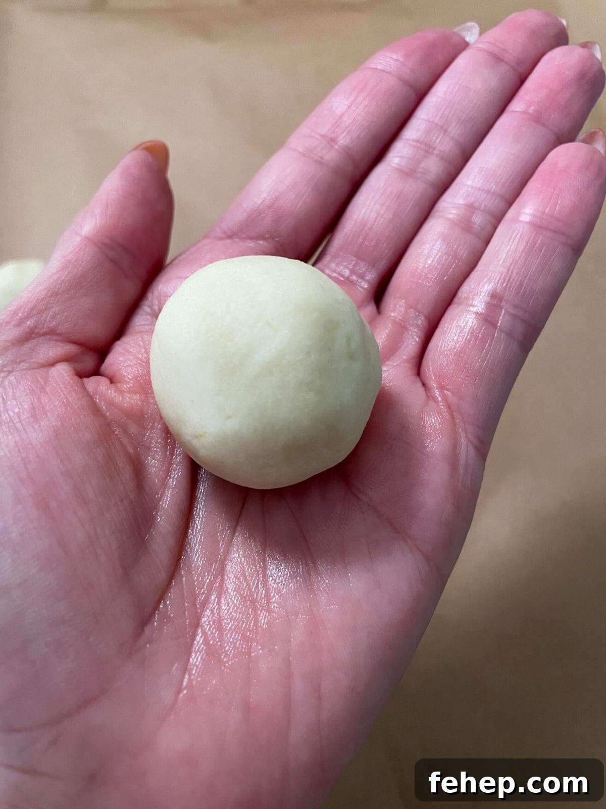Lemon Shortbread Cookies with Strawberry Glaze Recipe 7 balls of lemon shortbread cookie dough in hand