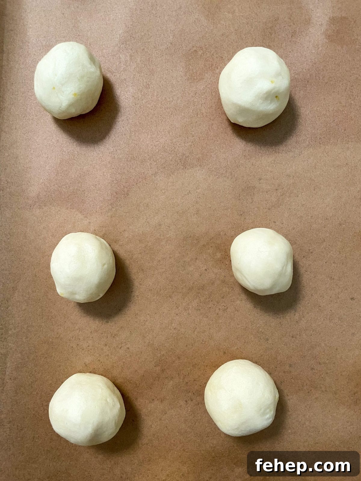 Lemon Shortbread Cookies with Strawberry Glaze Recipe 8 lemon shortbread cookie balls on baking sheet