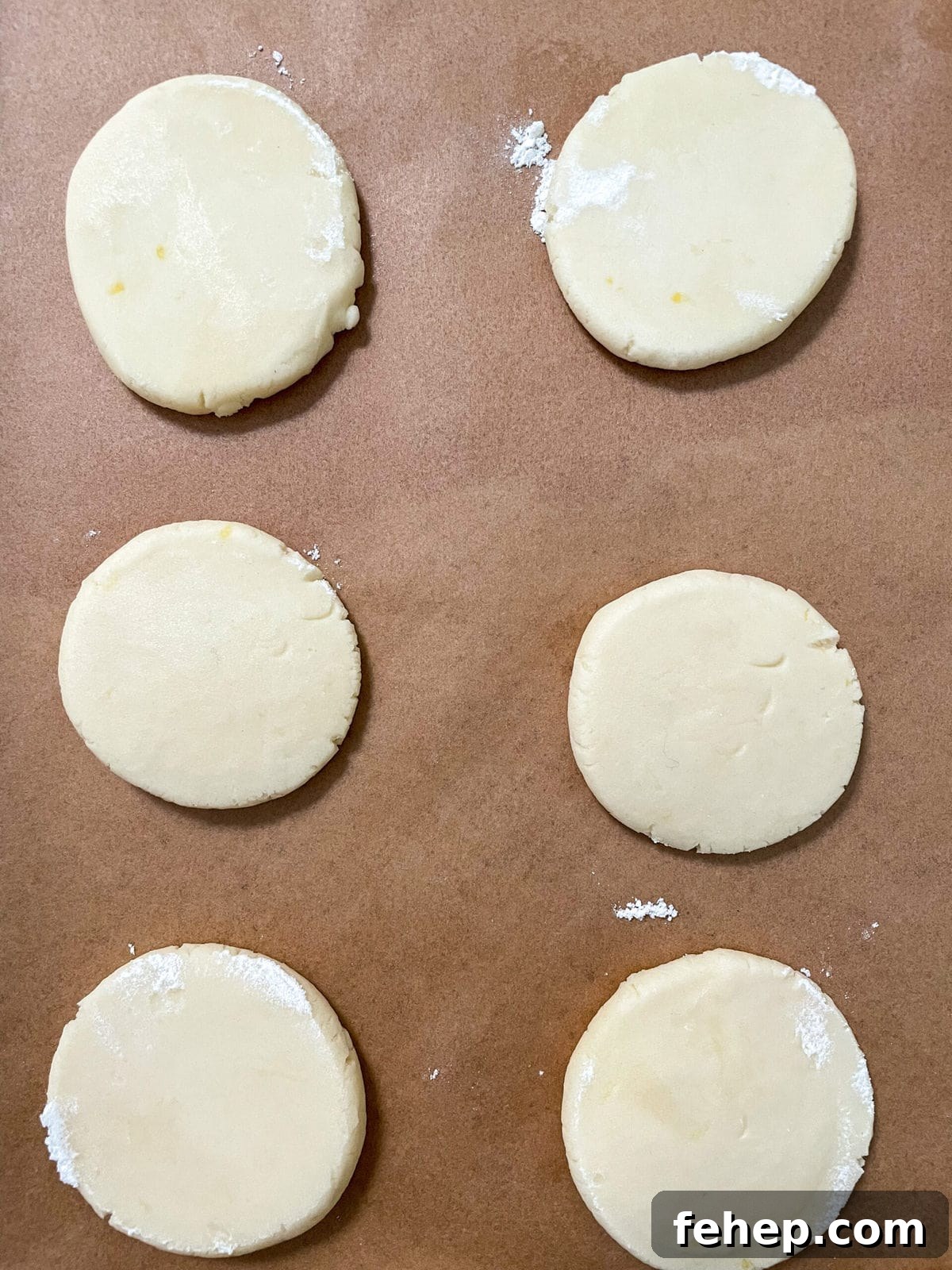 Lemon Shortbread Cookies with Strawberry Glaze Recipe 9 flattened lemon shortbread cookie dough on baking sheet