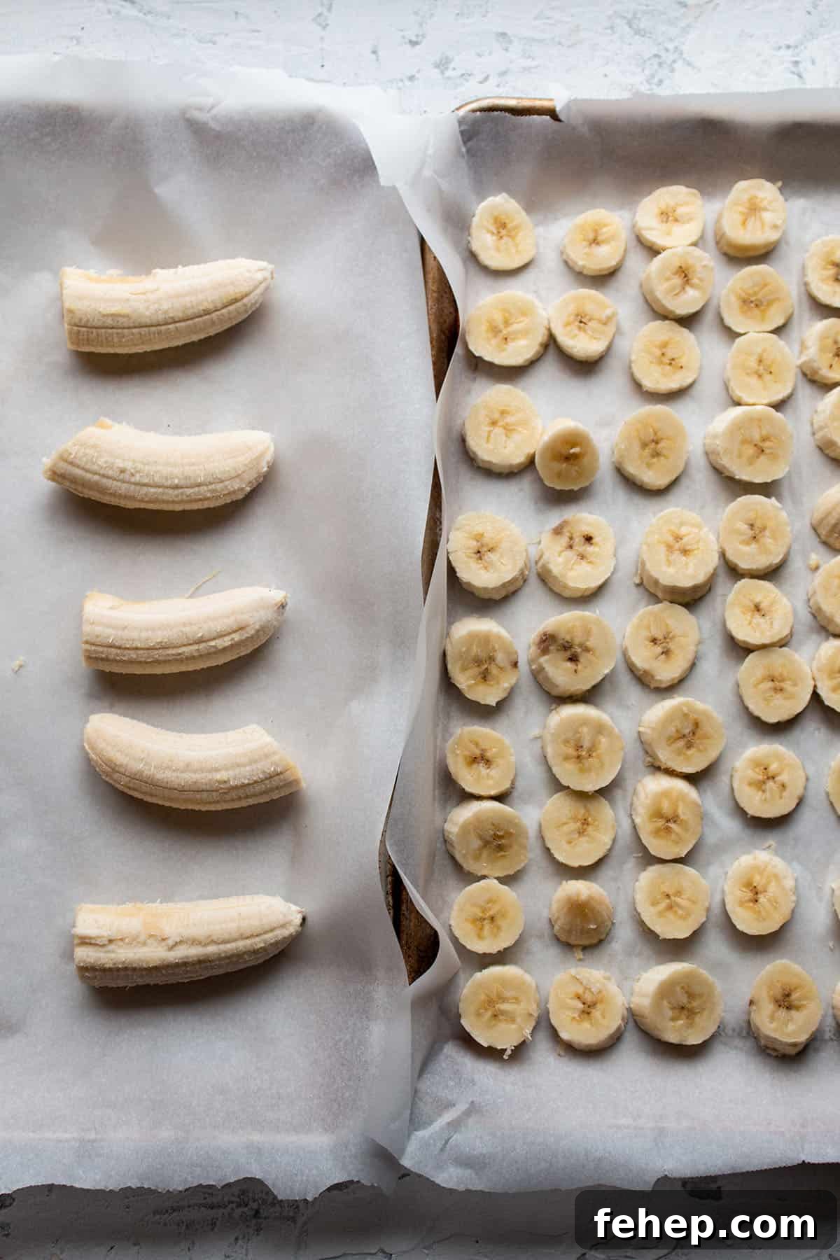 Freeze Bananas for Smoothies: Step-by-Step Guide and Tips 2 Two sheet pans with parchment and cut up bananas.