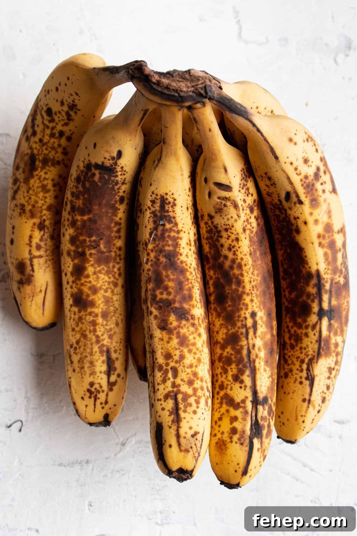 Freeze Bananas for Smoothies: Step-by-Step Guide and Tips 3 A bundle of overly ripe banana with brown speckles.