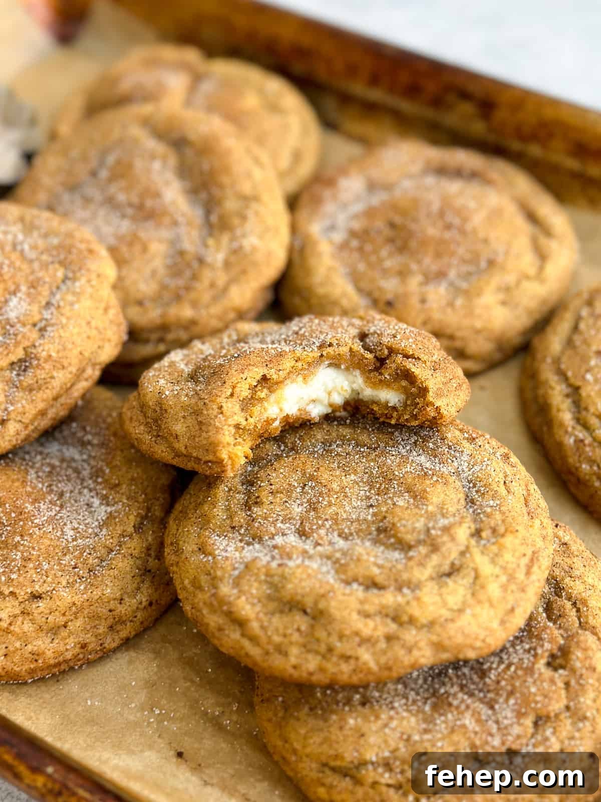 a bite from a pumpkin cheesecake snickerdoodle so you can see the cheesecake filling inside.