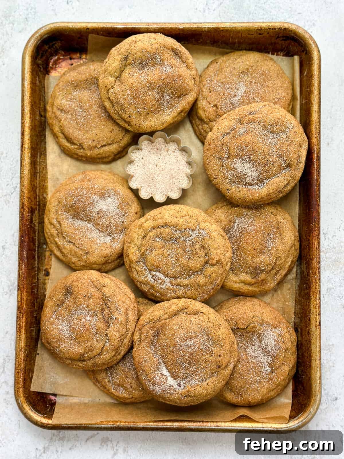 all the pumpkin cheesecake snickerdoodles layered on a baking sheet.
