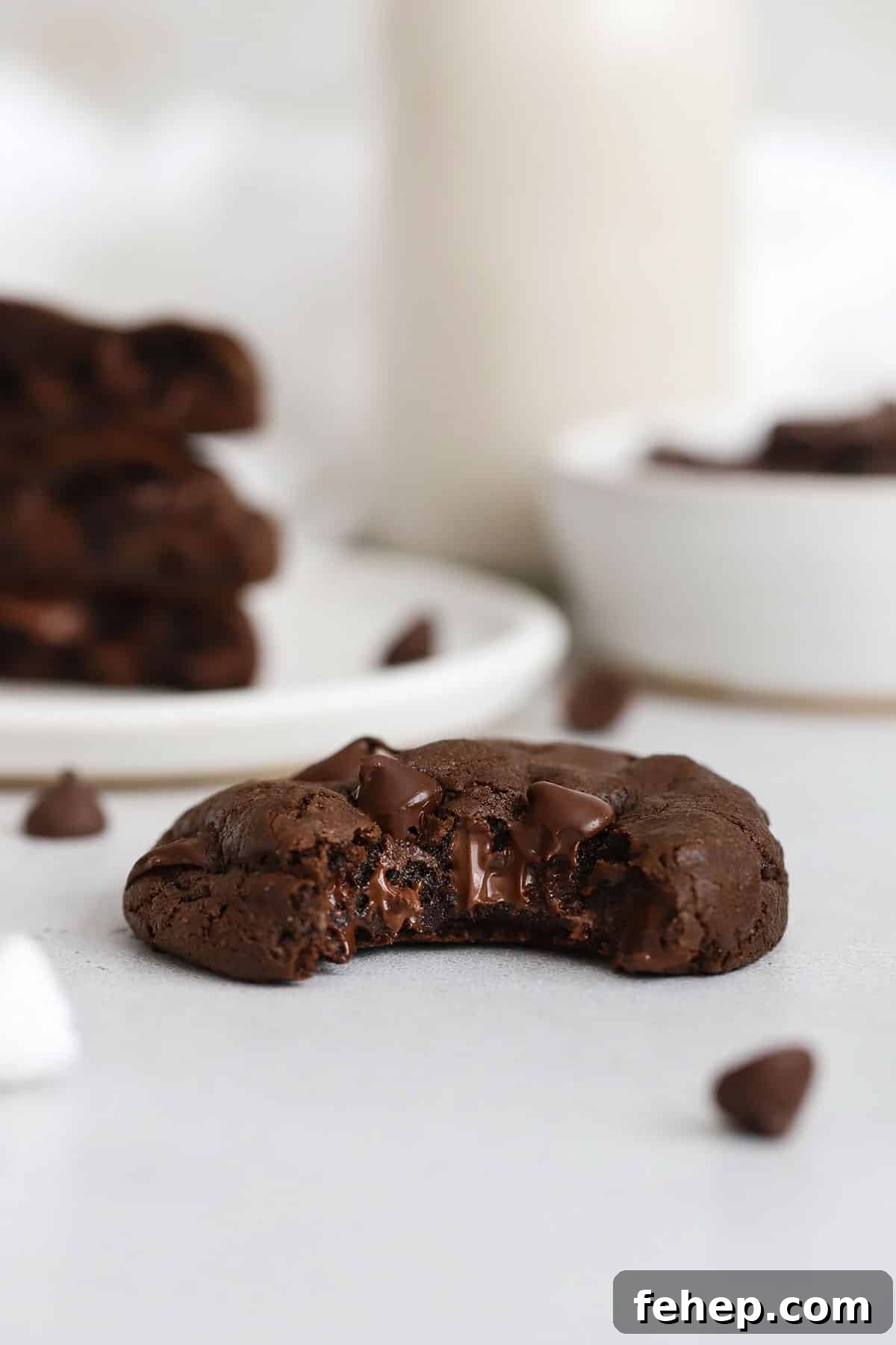 Gluten-free double chocolate chip cookie with a bite taken out of it