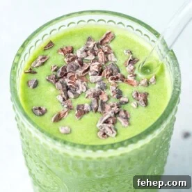 a cup full of shamrock shake topped with cocoa nibs.