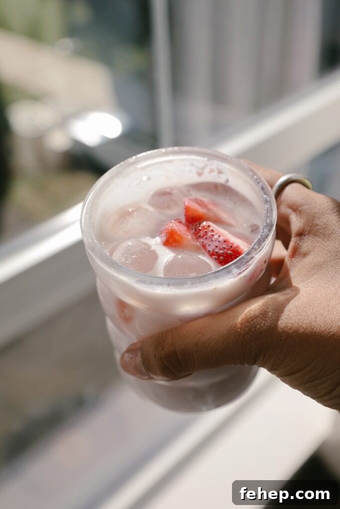hand holding glass with drink