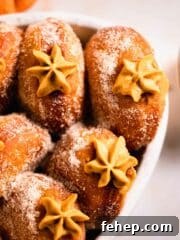 pumpkin donuts with piped filling peaking out in casserole dish