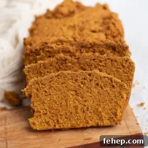 Sliced pumpkin bread on a wooden serving board