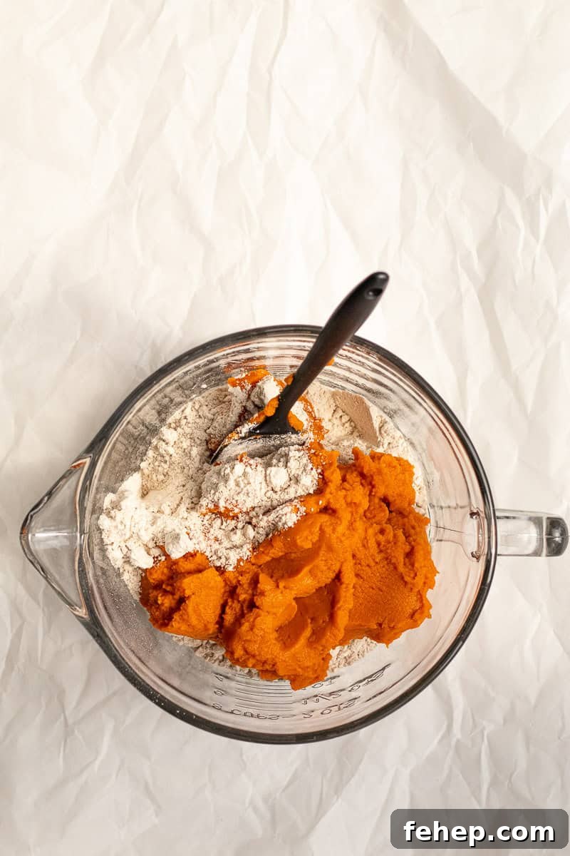 pumkin puree and spice cake mix in a glass bowl
