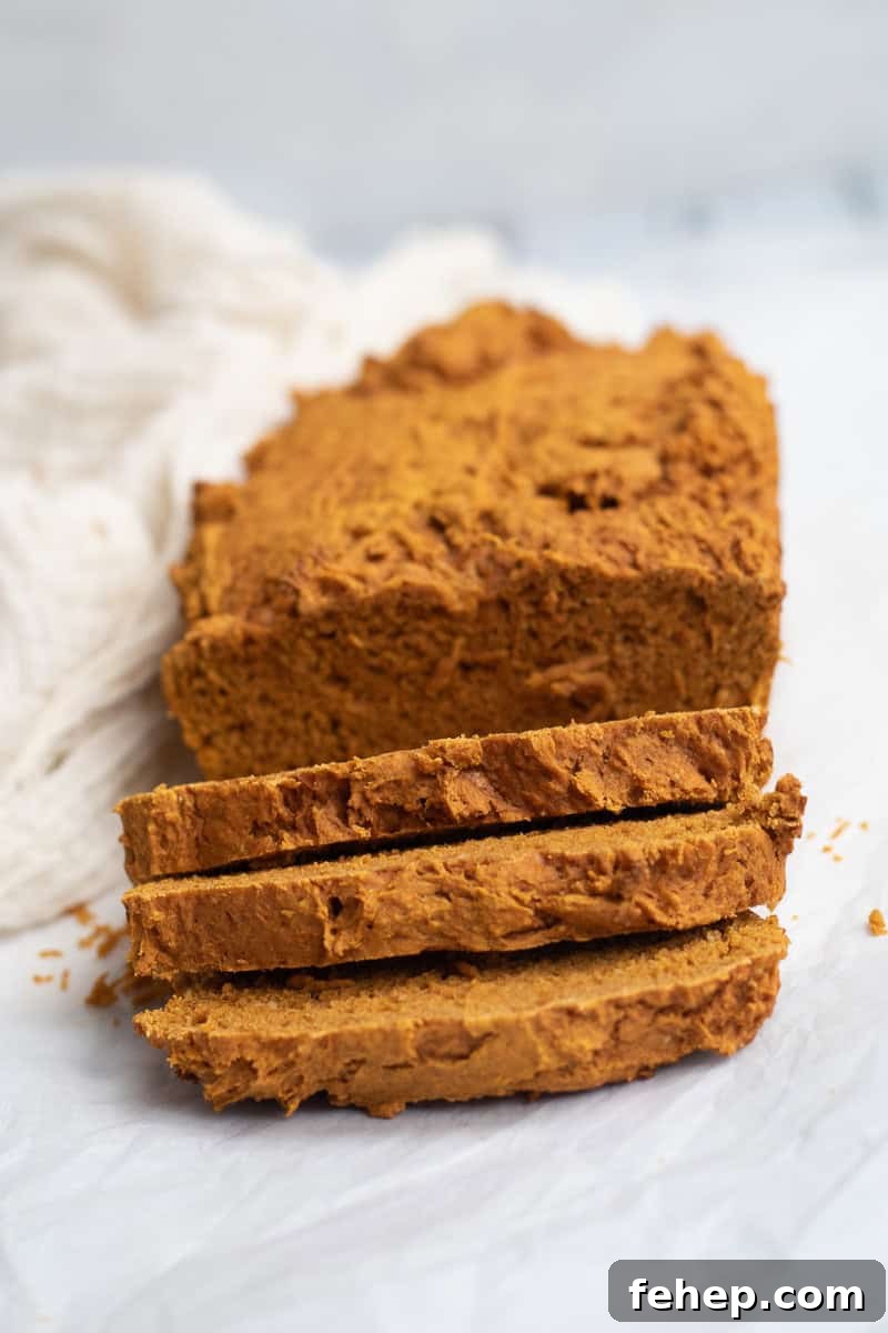 pumpkin bread sliced on parchment paper