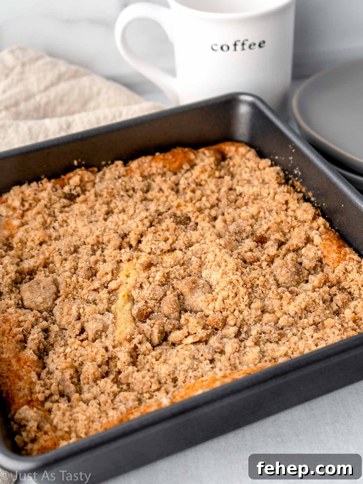 Cinnamon streusel coffee cake in a square baking pan.