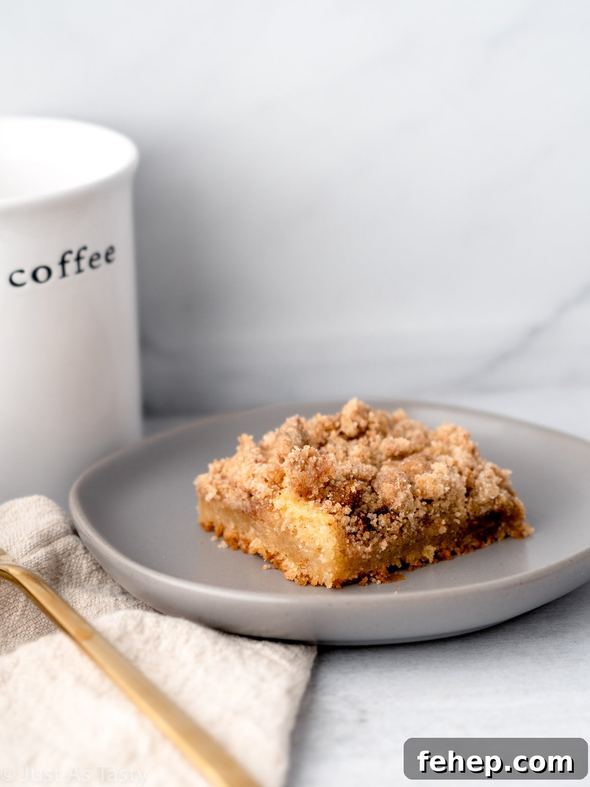 Close-up of a slice of coffee cake on a grey plate.