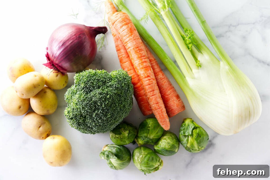 Assorted vegetables arranged on a marble countertop.