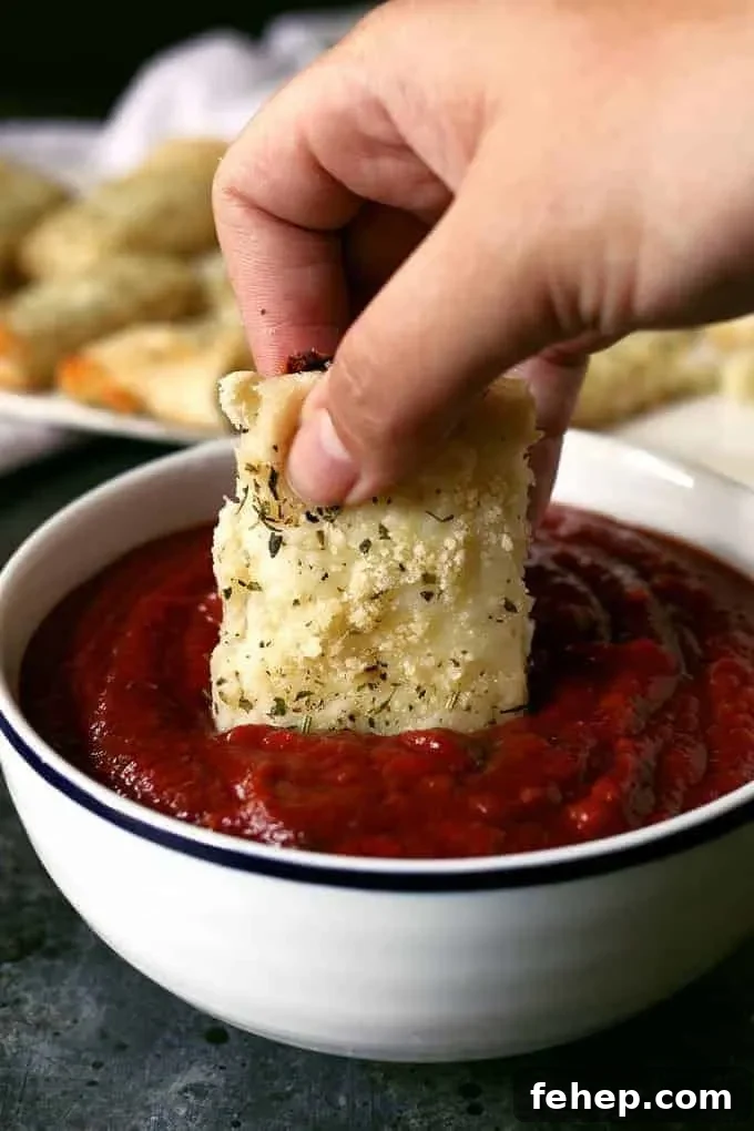 Chicago-Style deep dish breadsticks dipped into pizza sauce