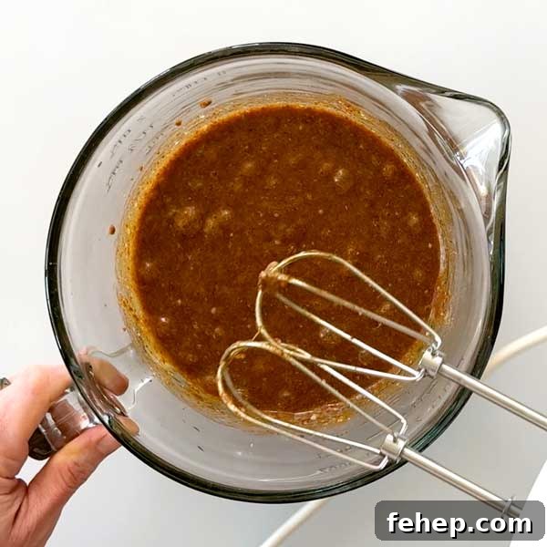 Cookie dough wet ingredients in a mixing bowl.