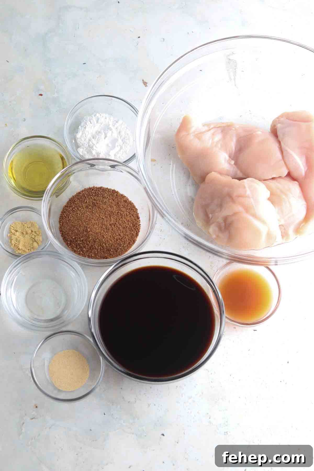Chicken teriyaki ingredients laid out in small glass bowls on the counter.